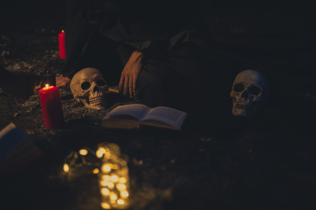 witchcraft-arrangement-with-candle-lights-dark